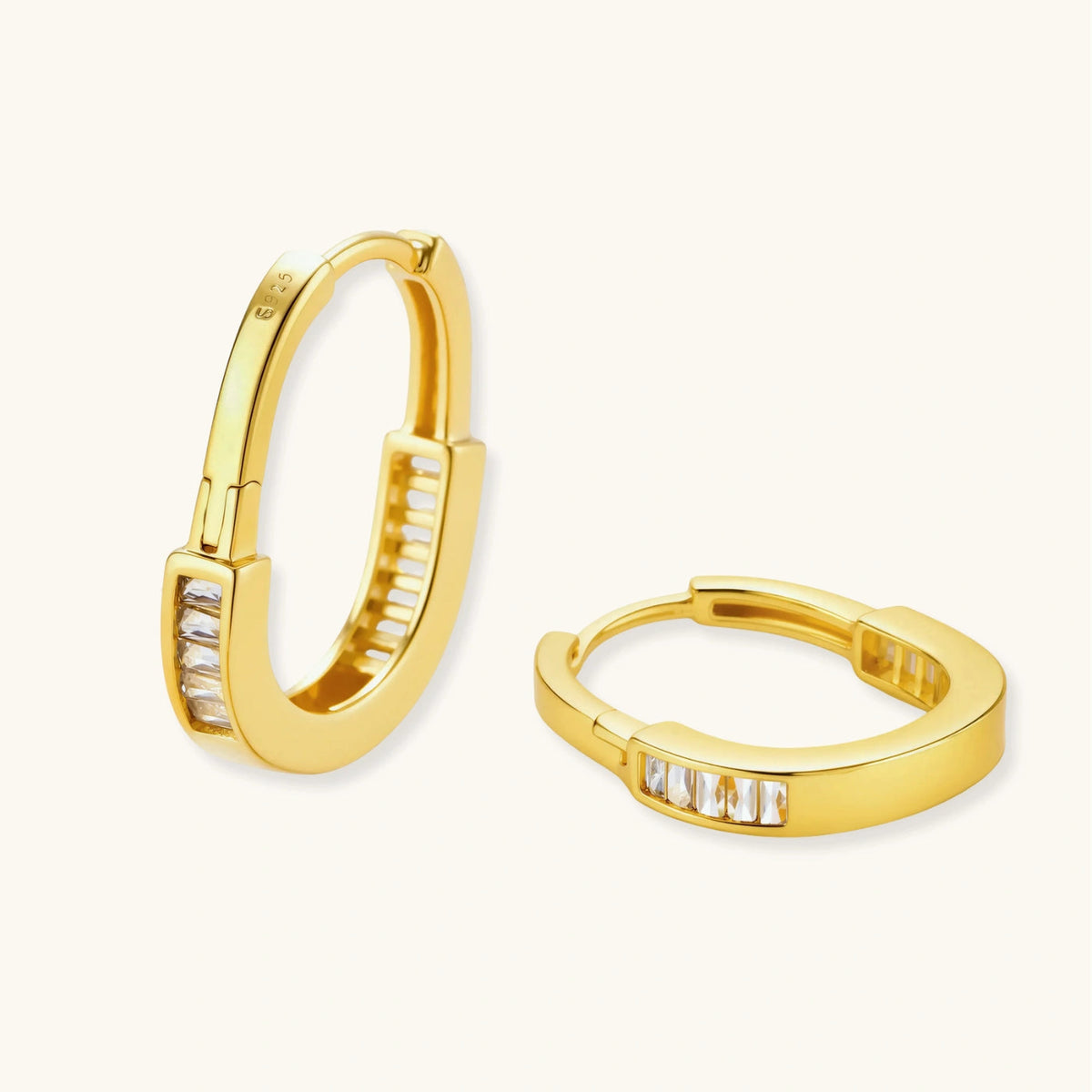 Golden Hour Huggie Hoops earrings photographed for VENIER on a warm ivory product set