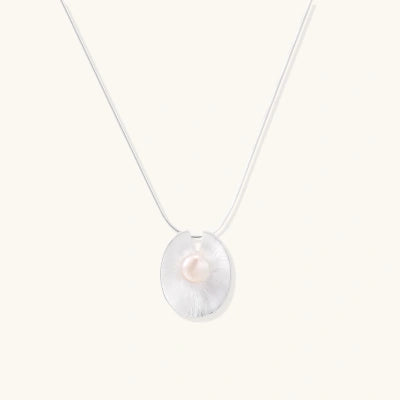 Pearl Cradle Necklace necklaces photographed for VENIER on a warm ivory product set