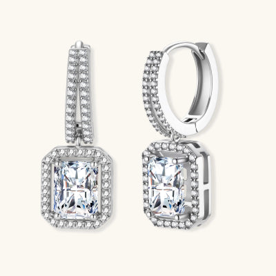 Emerald Cut Moissanite Drop Earrings earrings photographed for VENIER on a warm ivory product set