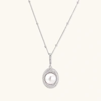 Pearl Halo Necklace necklaces photographed for VENIER on a warm ivory product set