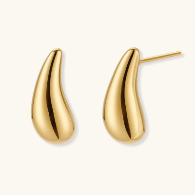 Golden Teardrop Studs earrings photographed for VENIER on a warm ivory product set