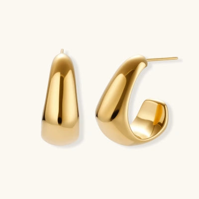 Sculpted Curve Huggies earrings photographed for VENIER on a warm ivory product set