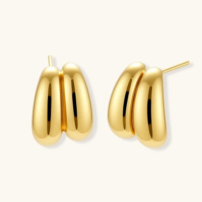 Liquid Gold Sculptural Hoops earrings photographed for VENIER on a warm ivory product set