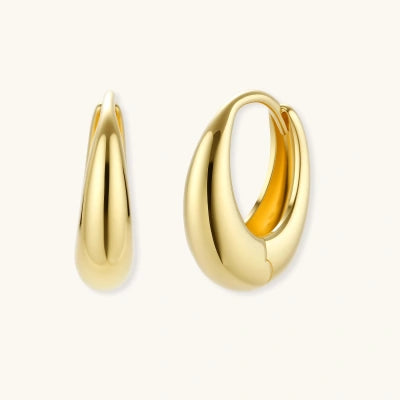 Golden Era Huggie Hoops earrings photographed for VENIER on a warm ivory product set