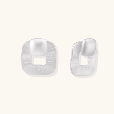 Textured Square Studs earrings photographed for VENIER on a warm ivory product set